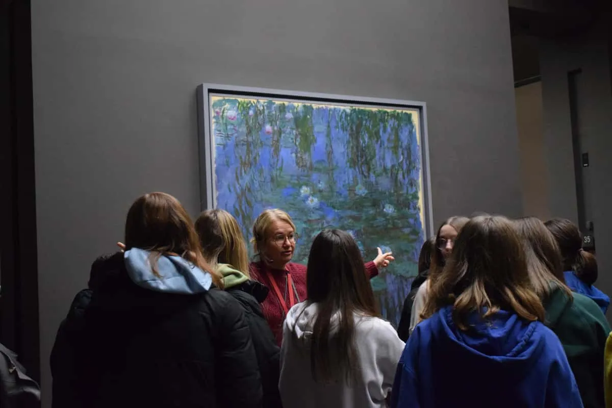 Visitors on a small-group tour viewing Impressionist works at the Musee d'Orsay in Paris